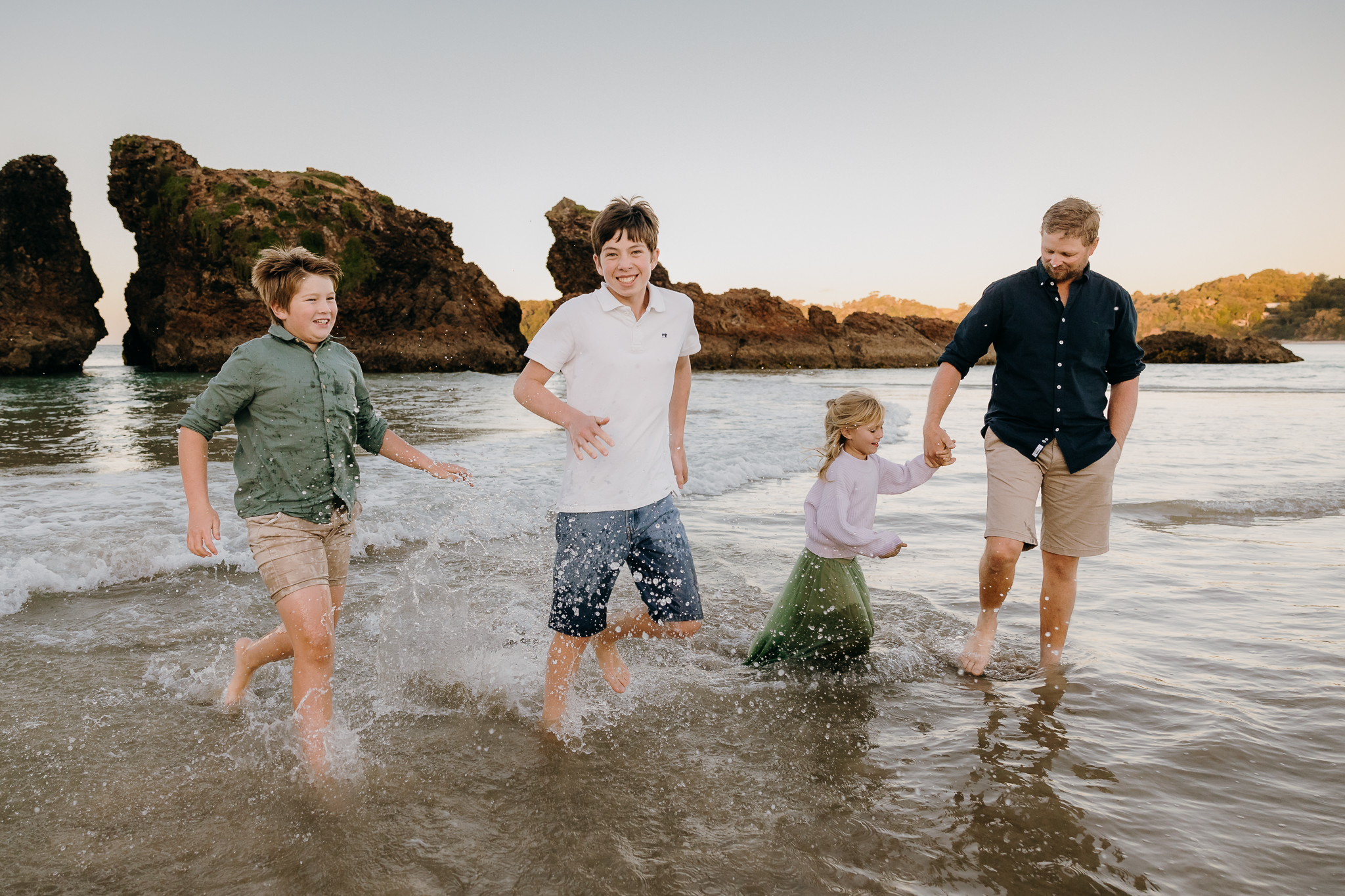 Family photos in the water at Whangarei beach.