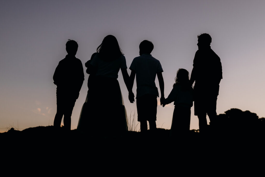 Silhouette family portrait at Woolley's Beach in Northland by Tracey Morris Photography.
